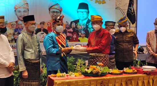 Gubernur Kalbar Sutarmidji memberikan potongan tumpeng kepada Ketua POM Agus Setiadi