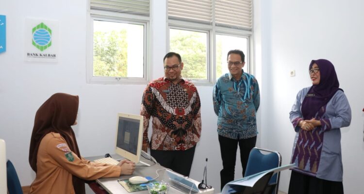 Pj Sekda Kalbar, Mohammad Bari meluncurkan bank mini di SMA 1 Pontianak, Jumat (12/01/2024). (Foto: Jauhari)